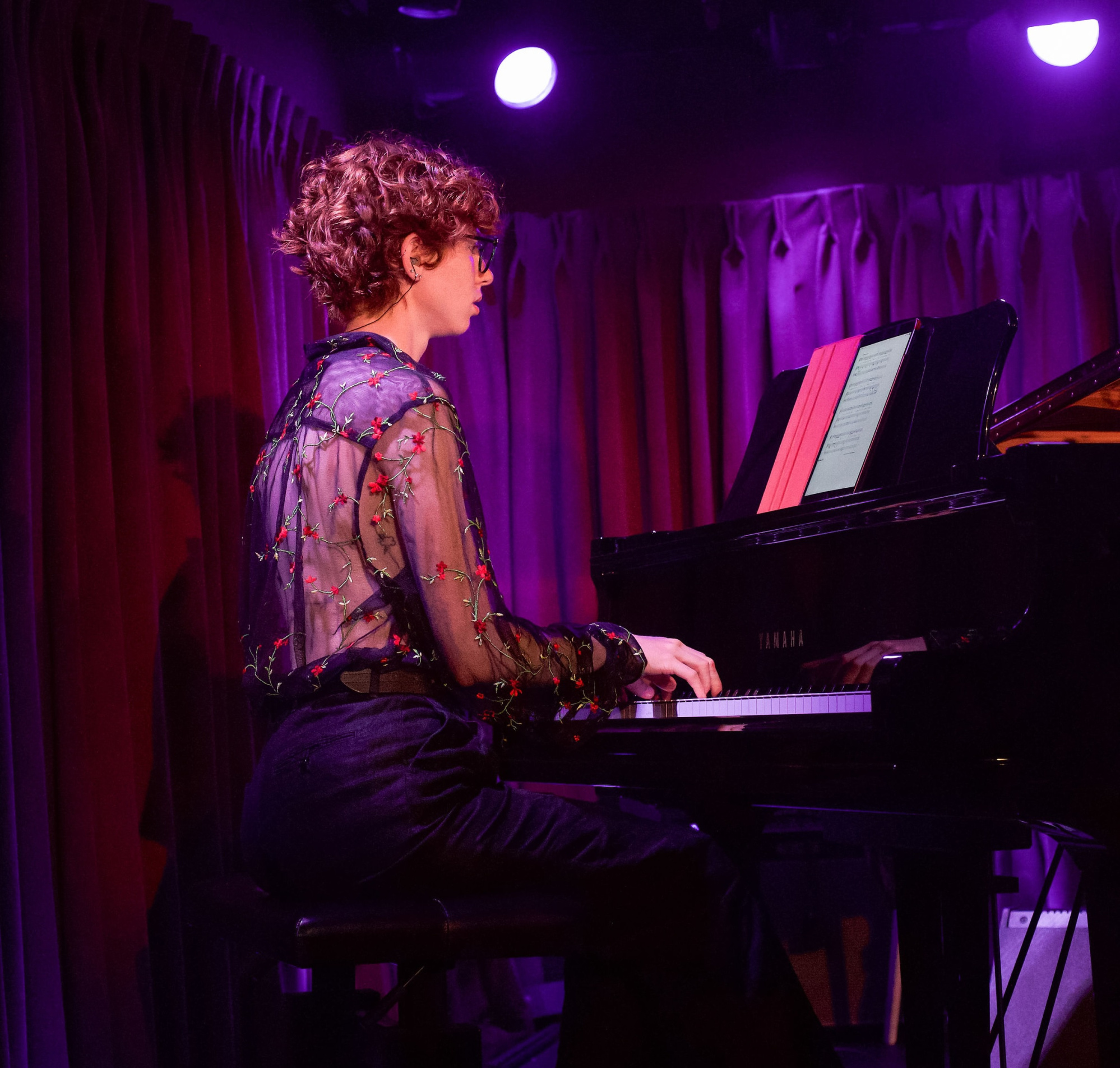 Julian is sitting at the piano.